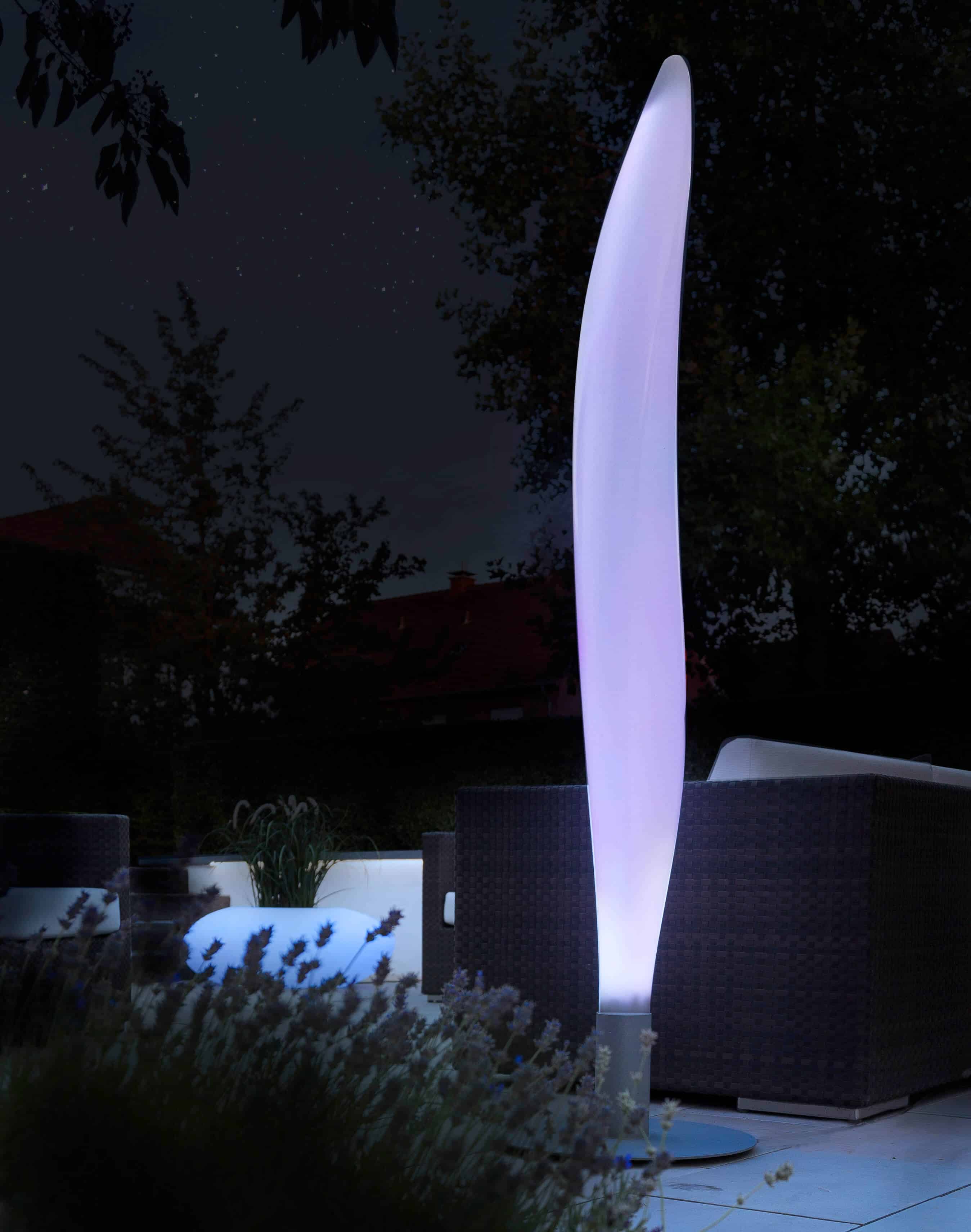Lunocs Flame LED-verlichting met zilvergrijs voetstuk verplaatst naar buiten, op de achtergrond Storus LED
